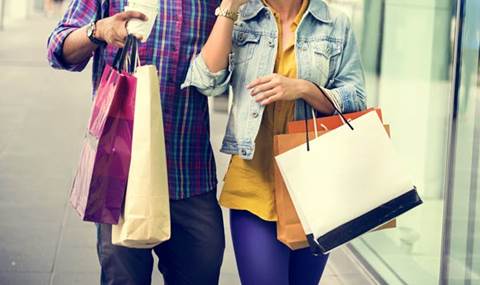 A couple walking with shopping bags.