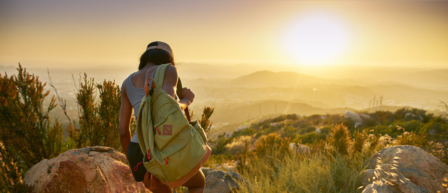 Young woman hiking at sunrise