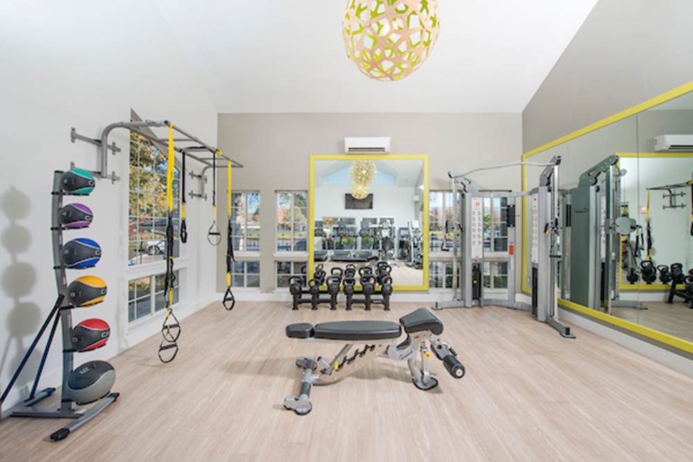 Fitness center with cardio and strength training equipment.