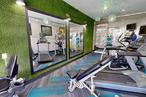 Fitness center with cardio and strength training equipment.