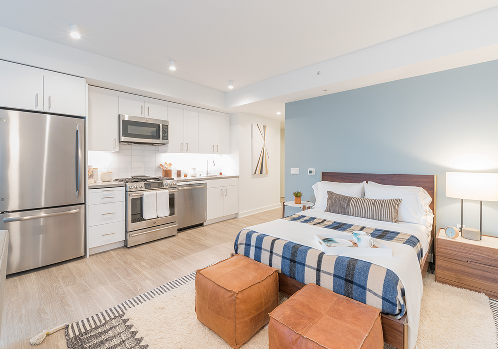 Open kitchen with stainless steel appliances in staged studio