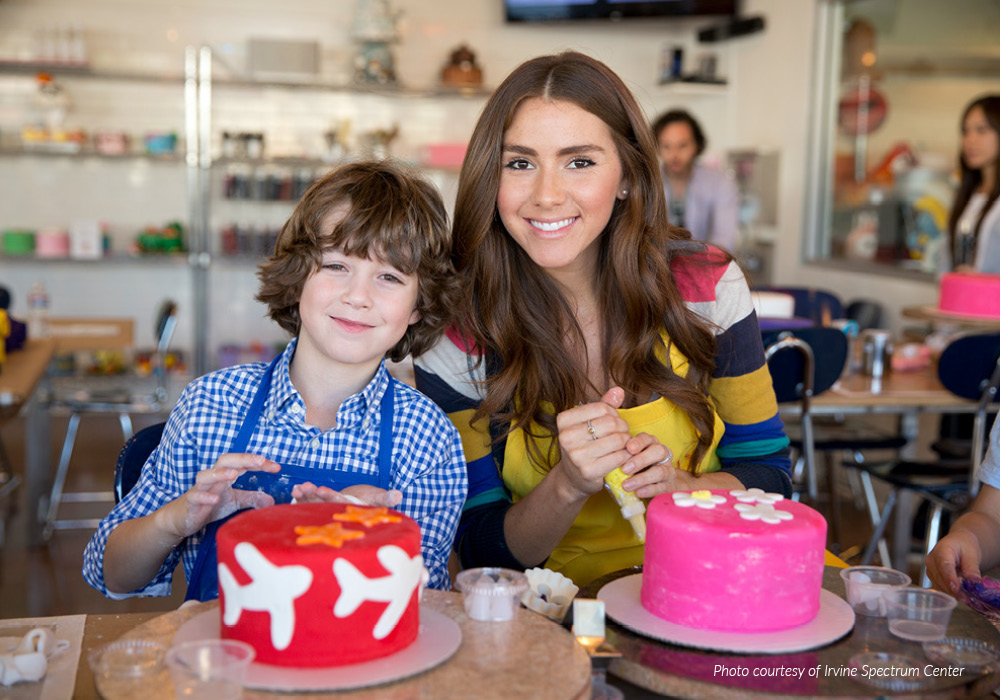 Girl and boy attending a cake decorating class.