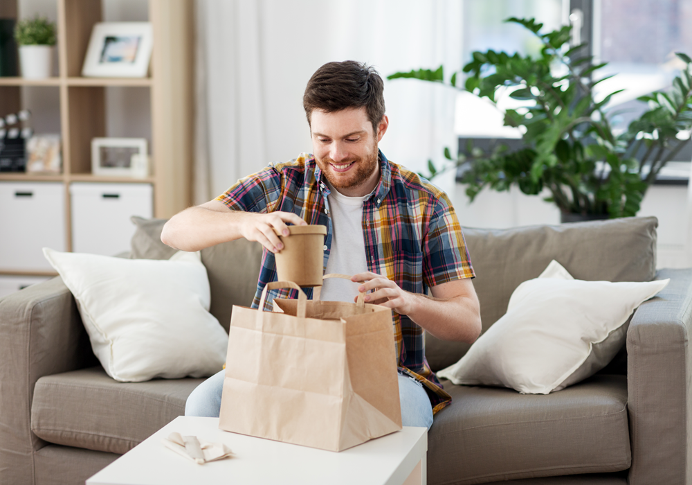 Man taking out his food delivery in his apartment home.