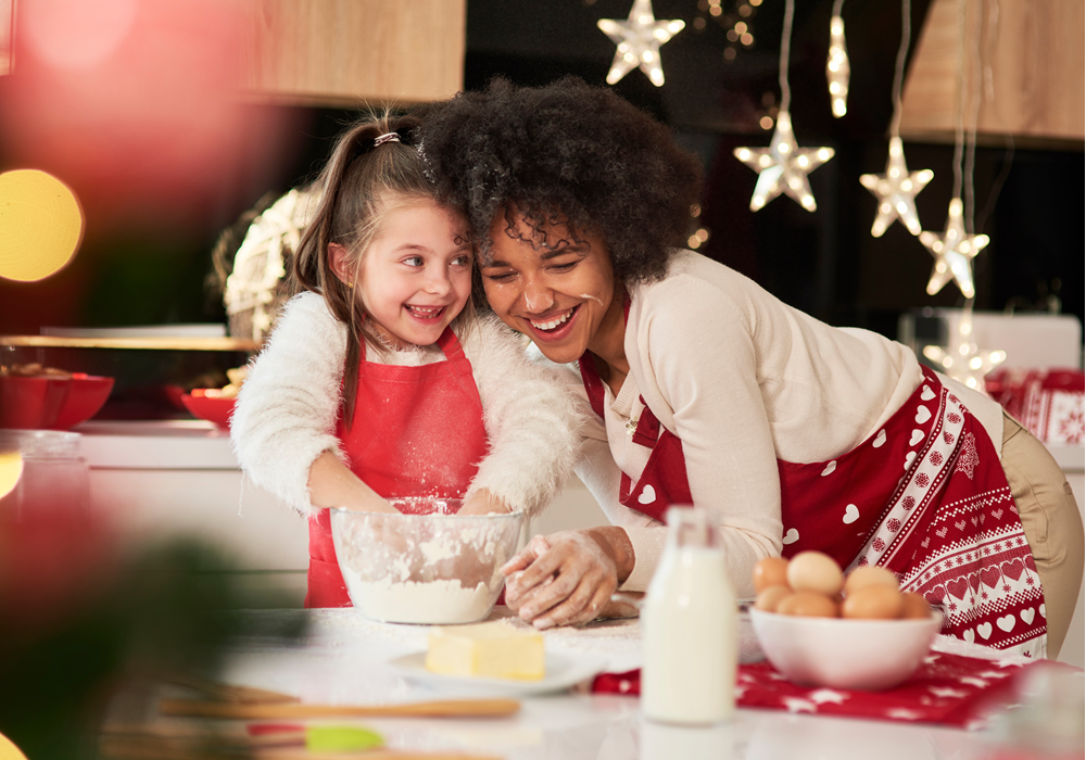 Woman and girl baking cookies in an apartment home.