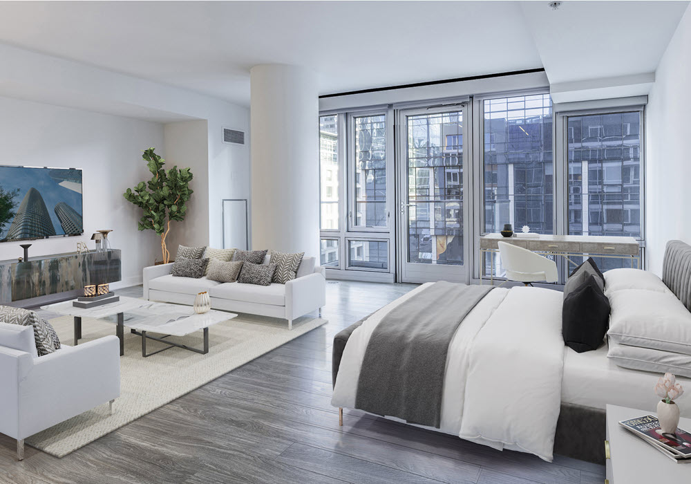 500 Folsom's staged studio apartment featuring bed, sofas, and a tv.