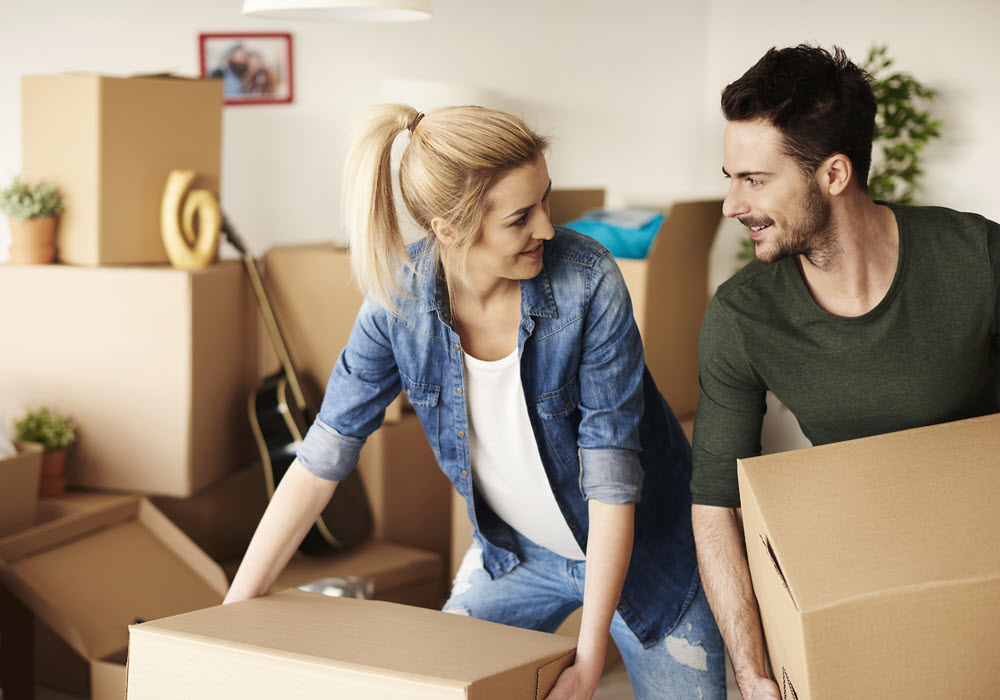 Couple unloading boxes on their apartment move-in day.