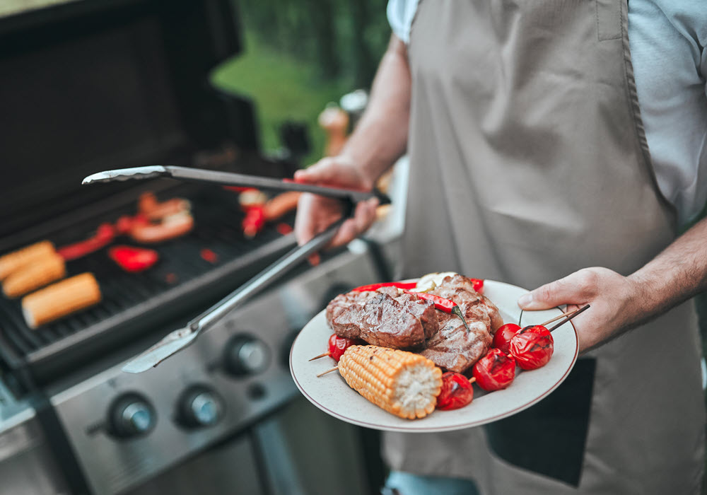 Chef grilling on a BBQ grill.