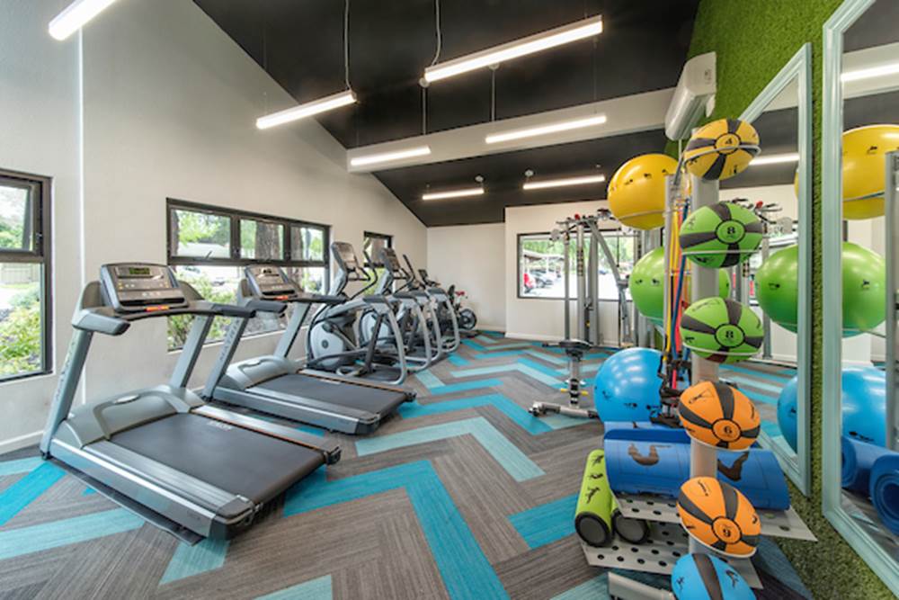 Fitness center with cardio and strength training equipment.