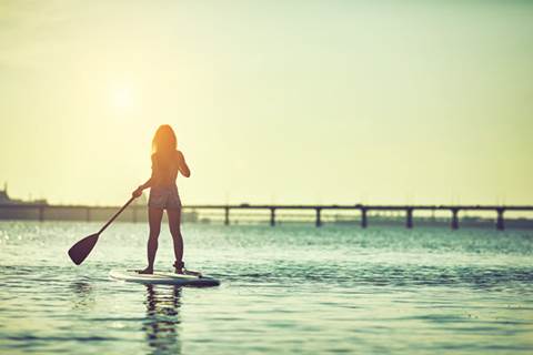 Woman paddleboarding.