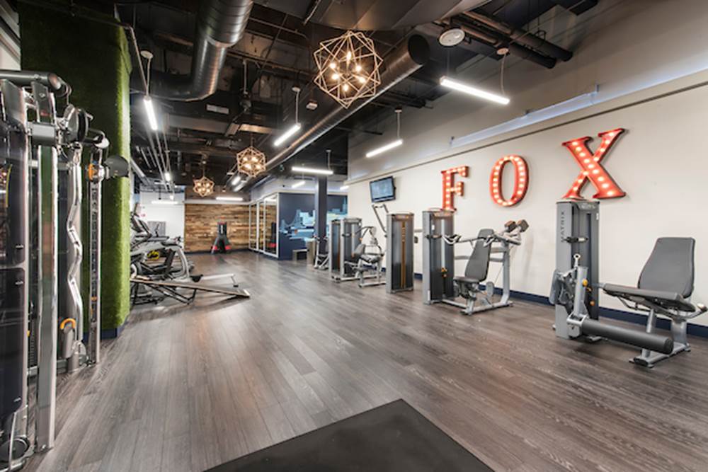 Fitness center with cardio and strength training equipment.