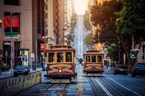 Street view of city and two trolleys.