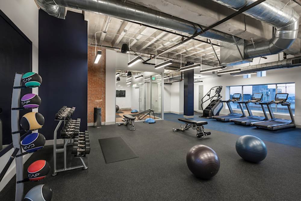 Fitness center with cardio and strength training equipment.