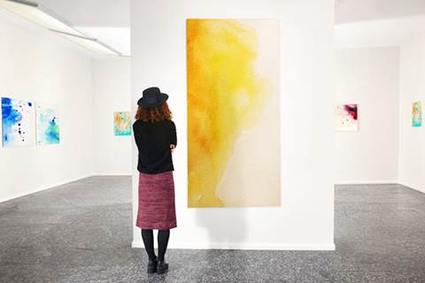 Woman looking at art piece in museum.