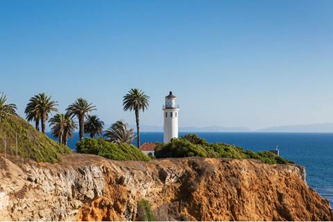 Edge of cliff featuring lighthouse in background.