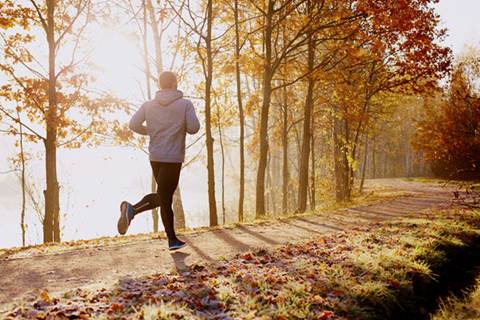 Man running on trail at golden hour