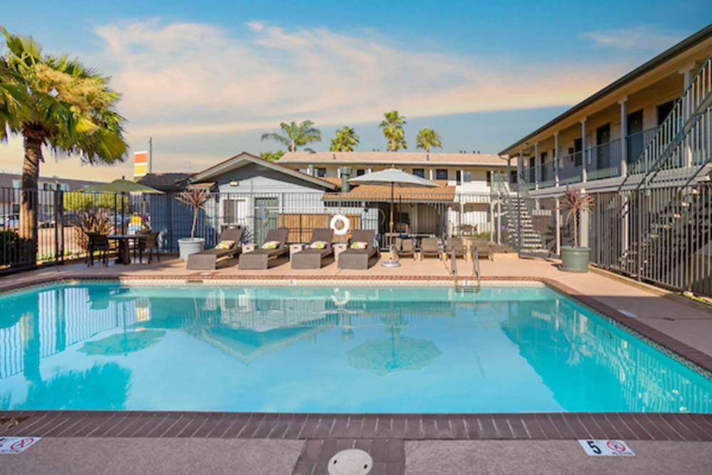 Outdoor swimming pool area with lounge seating.