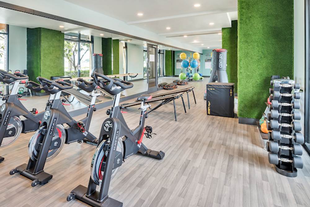 Fitness center with cardio and strength training equipment.