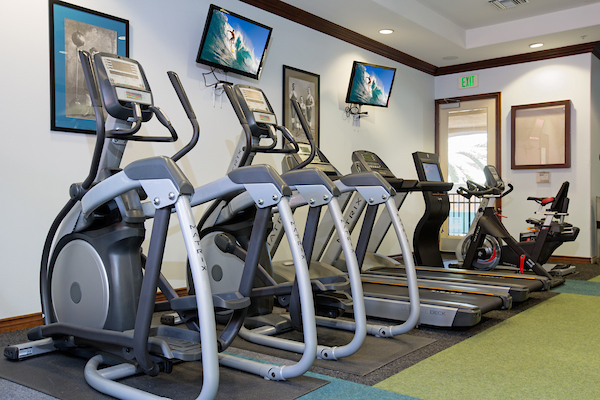 Fitness center with cardio and strength training equipment.