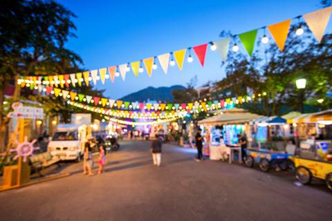 Night market with vendors and string lights.