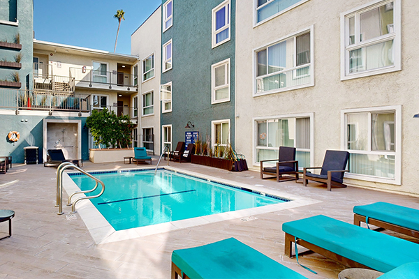 Outdoor swimming pool area with lounge seating.