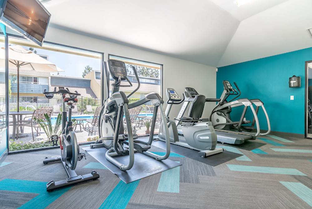 Fitness center with cardio and strength training equipment.